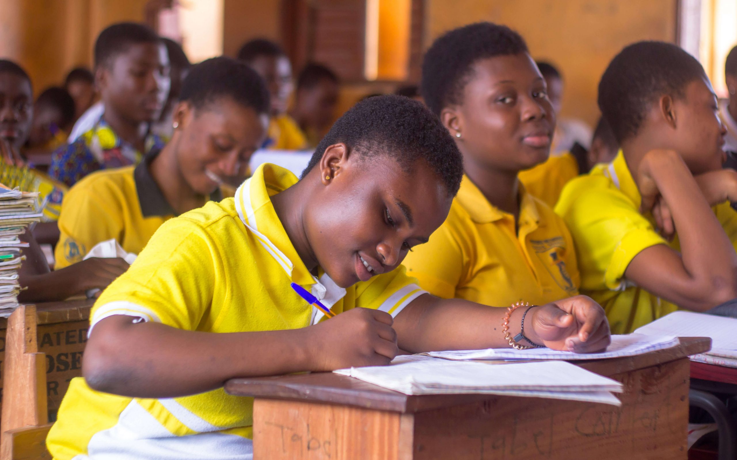 Female student creating personalized BECE study guide in class